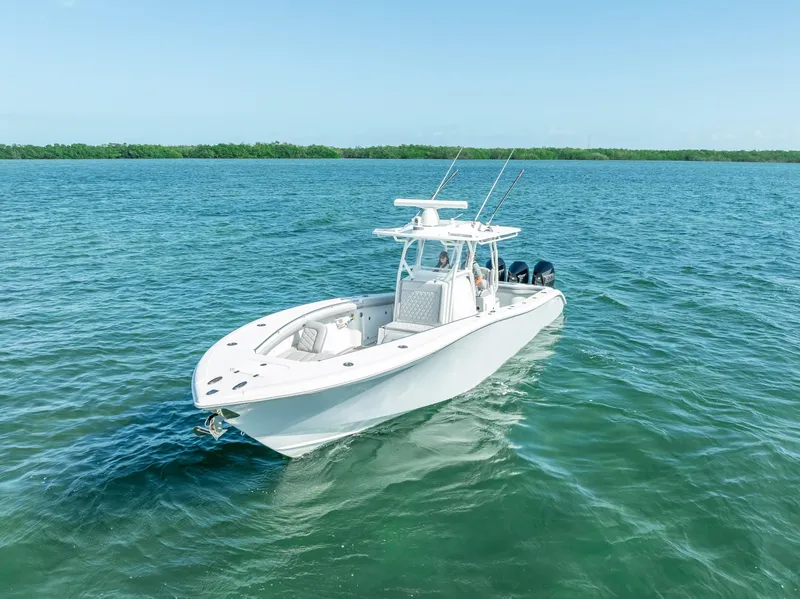 Slide: The Image of 2020 Yellowfin 34 boat cruising on clear blue water. - 5