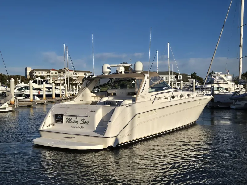 The Image of 1999 Sea Ray 50 SUNDANCER yacht docked in marina, clear sky background. - 0
