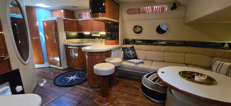 Slide: The Image of Luxurious interior of 1999 Sea Ray 50 Sundancer yacht with elegant seating and modern kitchen. - 12