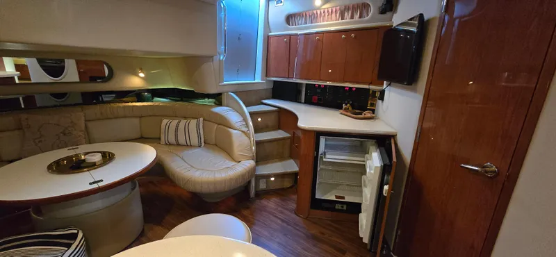 Slide: The Image of Luxurious interior of 1999 Sea Ray 50 Sundancer yacht with seating and kitchenette. - 13