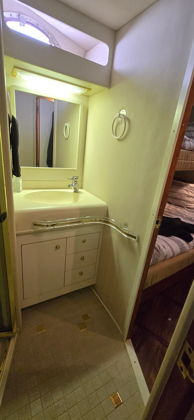 Slide: The Image of 1999 Sea Ray 50 Sundancer bathroom with sink, mirror, and storage cabinets. - 18