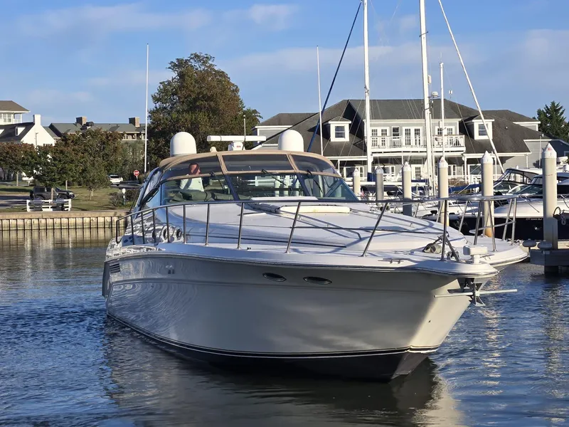 Slide: The Image of 1999 Sea Ray 50 SUNDANCER yacht docked in a marina, clear sky background. - 3