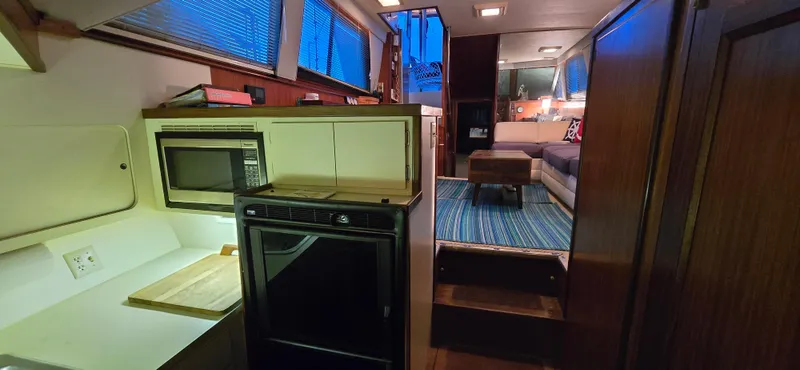 Slide: The Image of Interior of 1989 Hatteras 40 Double Cabin with kitchen and cozy living area. - 10