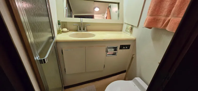 Slide: The Image of Bathroom interior of 1989 Hatteras 40 Double Cabin yacht with sink and shower. - 12
