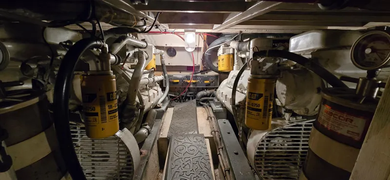 Slide: The Image of Engine room of 1989 Hatteras 40 Double Cabin with visible machinery and filters. - 18
