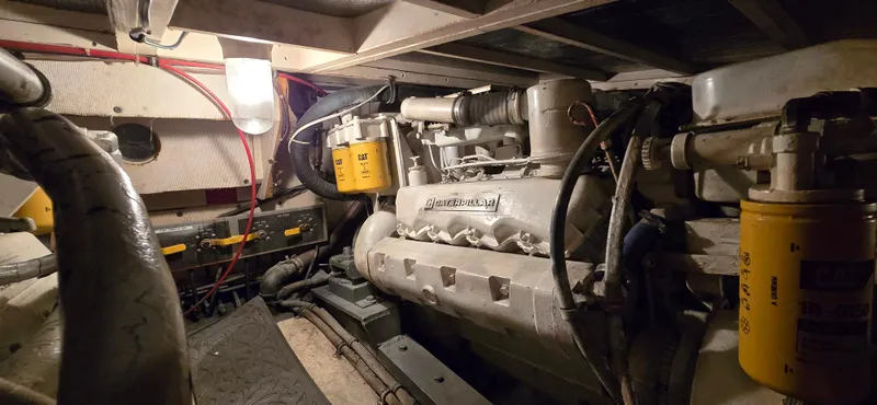 Slide: The Image of Engine room of 1989 Hatteras 40 Double Cabin yacht, showcasing mechanical components. - 19