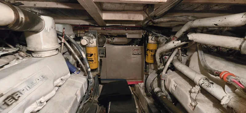 Slide: The Image of Engine room of 1989 Hatteras 40 Double Cabin with visible machinery and pipes. - 21