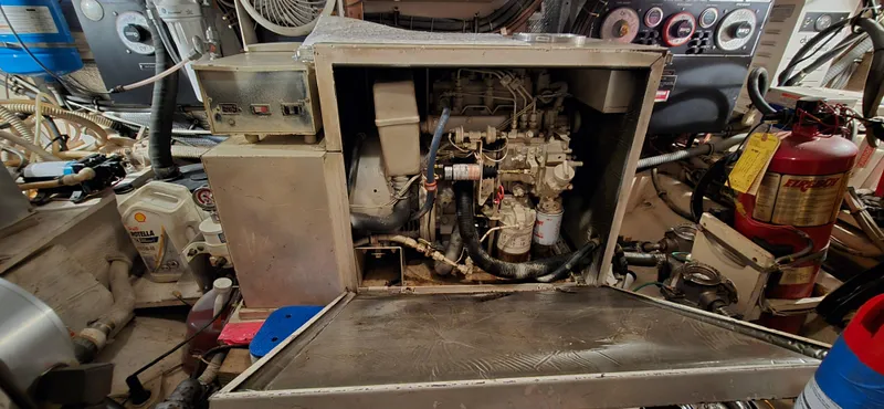 Slide: The Image of Engine room of 1989 Hatteras 40 Double Cabin with visible machinery and equipment. - 24
