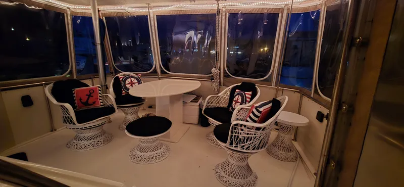 Slide: The Image of Interior of 1989 Hatteras 40 Double Cabin with stylish seating and nautical decor. - 5