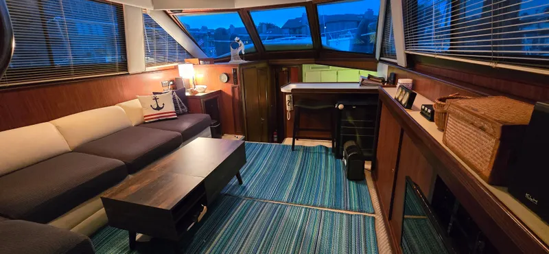 Slide: The Image of Interior of 1989 Hatteras 40 Double Cabin with cozy seating and nautical decor. - 6