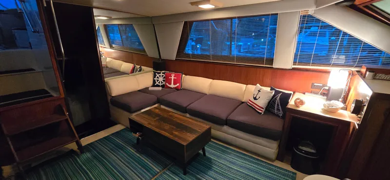 Slide: The Image of Interior of 1989 Hatteras 40 Double Cabin with cozy seating and nautical decor. - 7