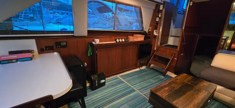Slide: The Image of Interior of 1989 Hatteras 40 Double Cabin with dining area and wooden accents. - 8
