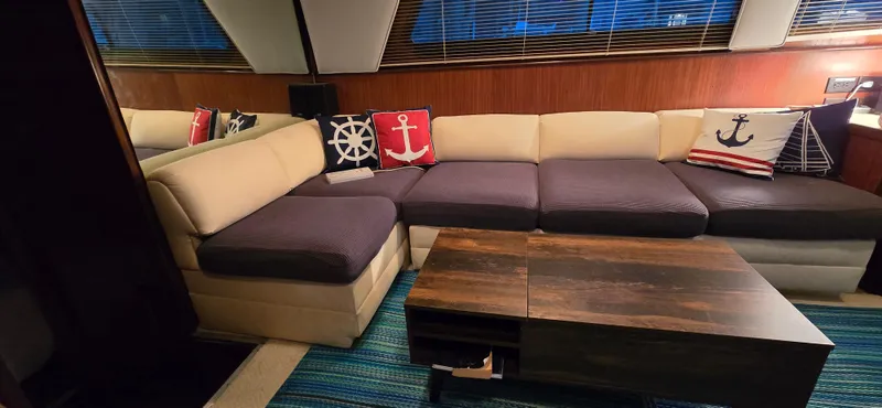 Slide: The Image of Interior of 1989 Hatteras 40 Double Cabin with nautical-themed cushions and modern decor. - 9