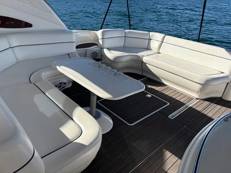Slide: The Image of Luxurious 1999 Sea Ray 540 Sundancer yacht with spacious white seating and wooden deck. - 16