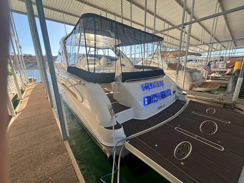 Slide: The Image of 1999 Sea Ray 540 Sundancer docked in a marina, covered and ready for sailing. - 19