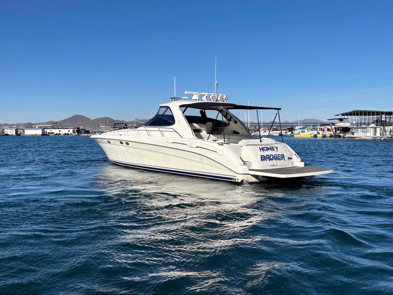 Slide: The Image of 1999 Sea Ray 540 Sundancer yacht on open water, clear sky background. - 2