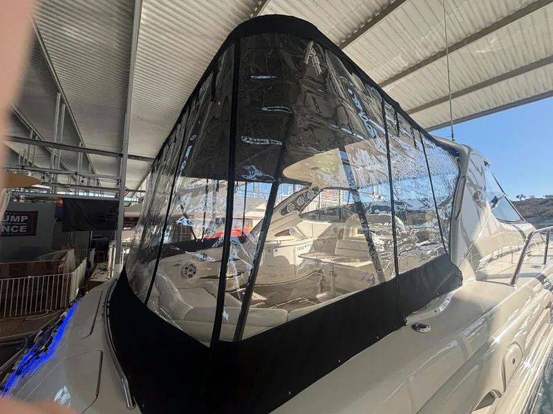 Slide: The Image of 1999 Sea Ray 540 Sundancer yacht with clear enclosure in a marina. - 20