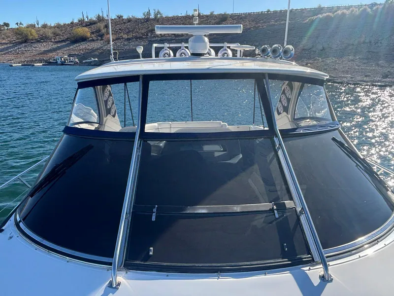 Slide: The Image of 1999 Sea Ray 540 Sundancer yacht on water, front view with sunlit deck. - 24