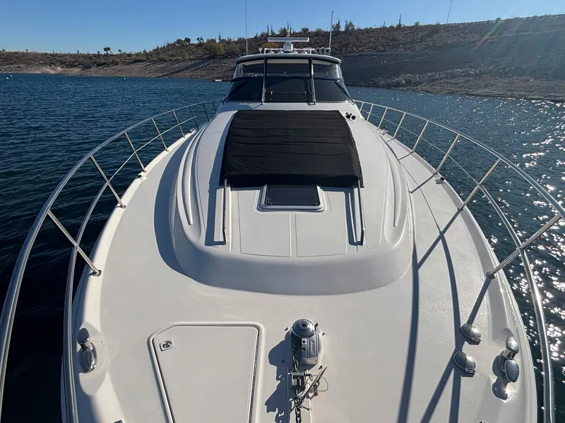 Slide: The Image of 1999 Sea Ray 540 Sundancer yacht on calm water, front deck view. - 26