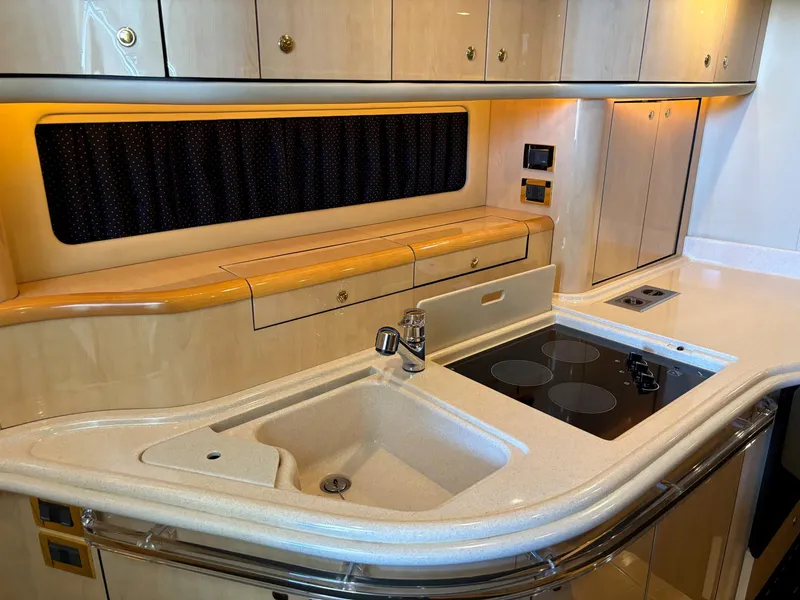 Slide: The Image of Luxurious kitchen area in 1999 Sea Ray 540 Sundancer yacht with modern amenities. - 34