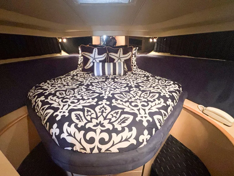 Slide: The Image of Luxurious 1999 Sea Ray 540 Sundancer cabin with elegant bedding and starfish-themed pillows. - 39