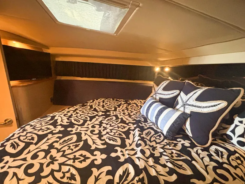 Slide: The Image of Luxurious cabin interior of 1999 Sea Ray 540 Sundancer with elegant bedding. - 40