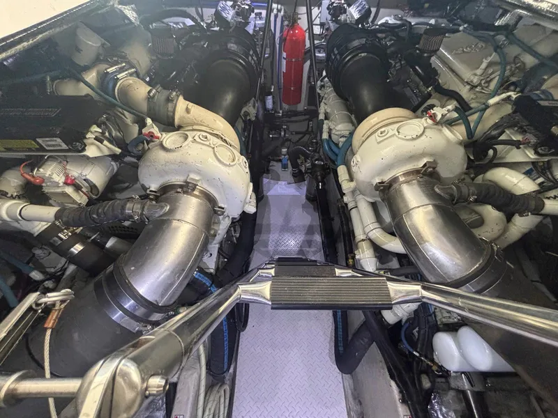 Slide: The Image of Engine room of 1999 Sea Ray 540 Sundancer with dual engines and fire extinguisher. - 42