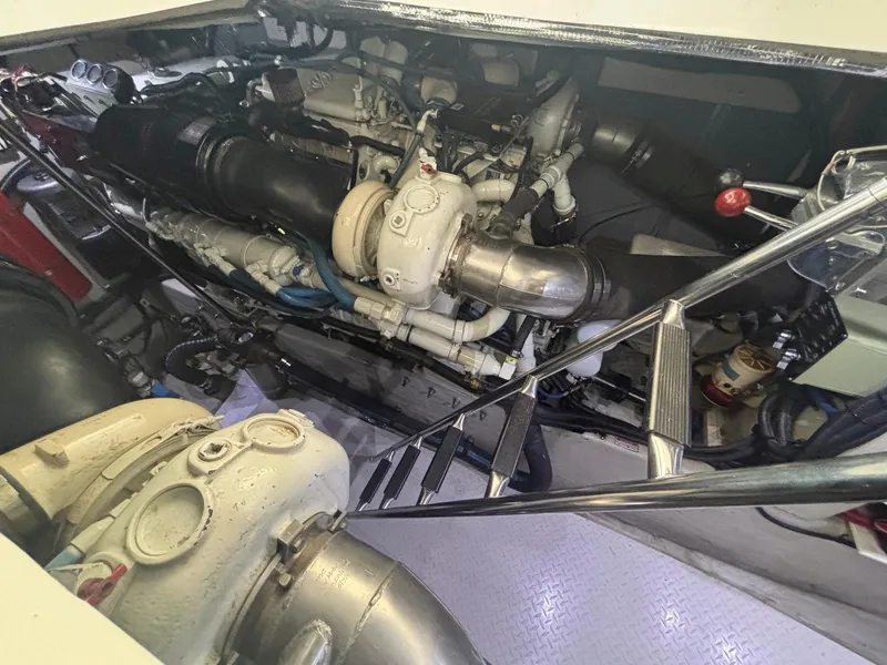 Slide: The Image of Engine room of 1999 Sea Ray 540 Sundancer yacht, showcasing mechanical components and piping. - 44