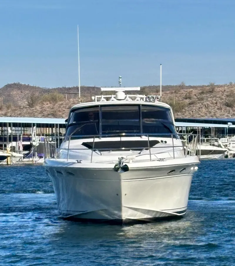 Slide: The Image of 1999 Sea Ray 540 Sundancer yacht on water, marina in background. - 5