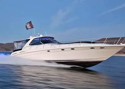 Slide: The Image of 1999 Sea Ray 540 Sundancer yacht cruising on open water. - 7