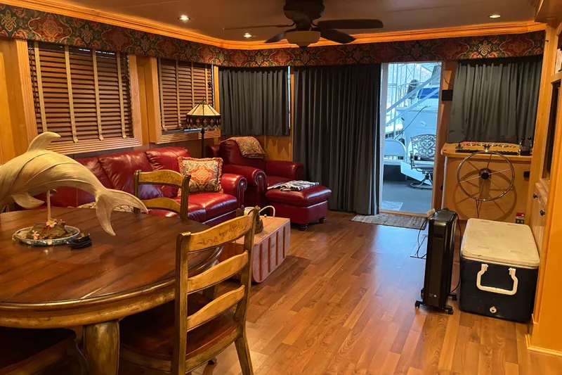 Slide: The Image of Cozy houseboat interior with red leather seating, wooden dining table, and nautical decor. - 10