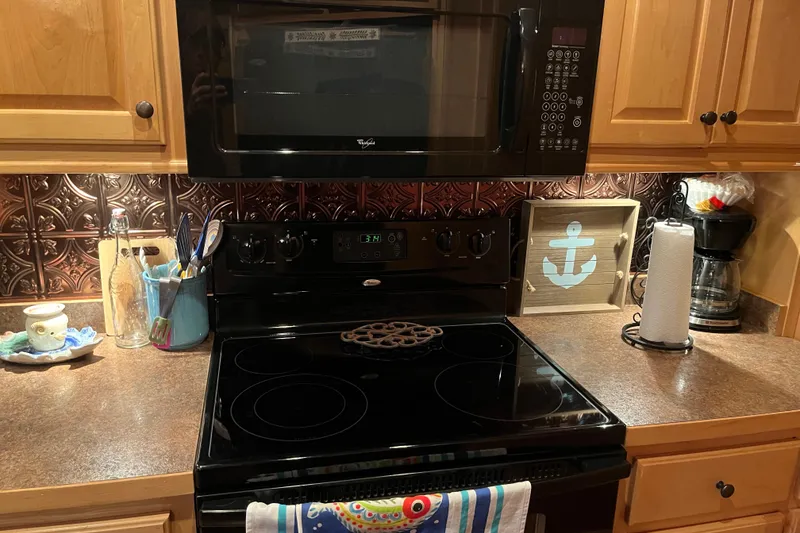 Slide: The Image of Modern kitchen with black stove, microwave, and decorative backsplash. Funtime 68x16 model, 2010. - 16