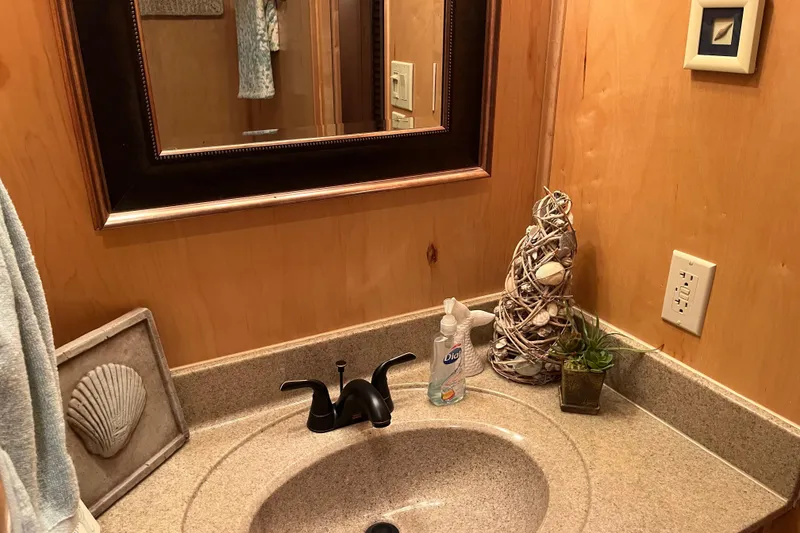 Slide: The Image of Bathroom sink with decorative seashells, mirror, and soap dispenser in a Funtime 68x16, 2010 model. - 20