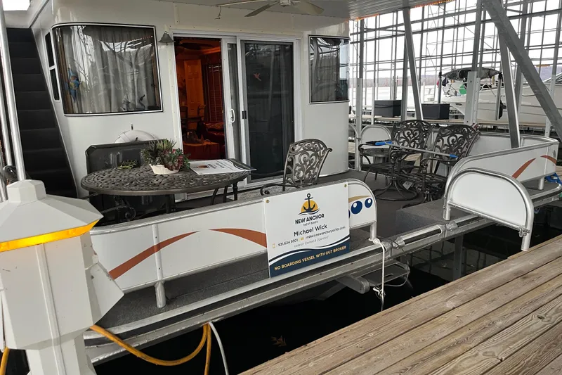 Slide: The Image of Houseboat docked with outdoor seating, Funtime 68x16 model, 2010. - 3
