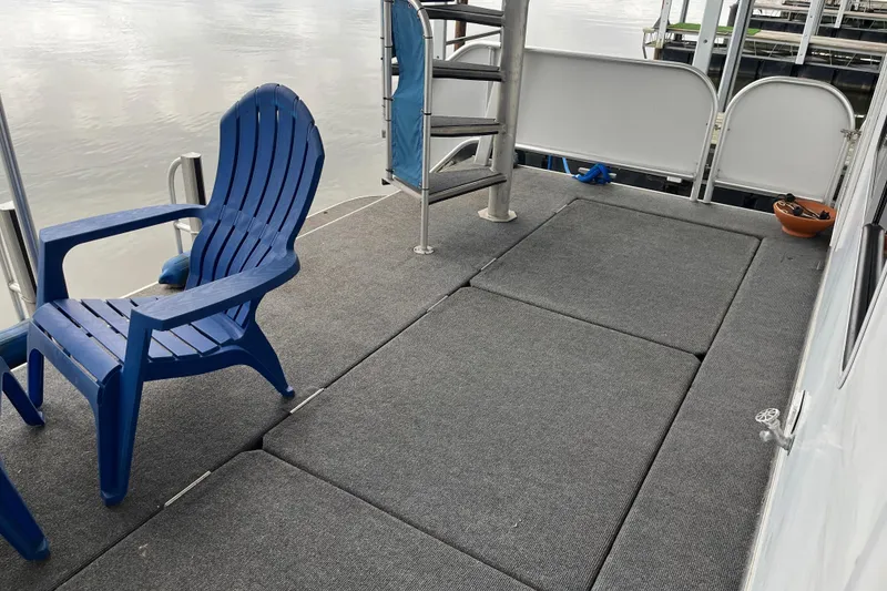 Slide: The Image of Blue chair on Funtime 68x16 boat deck, 2010 model, with gray flooring and railing. - 31