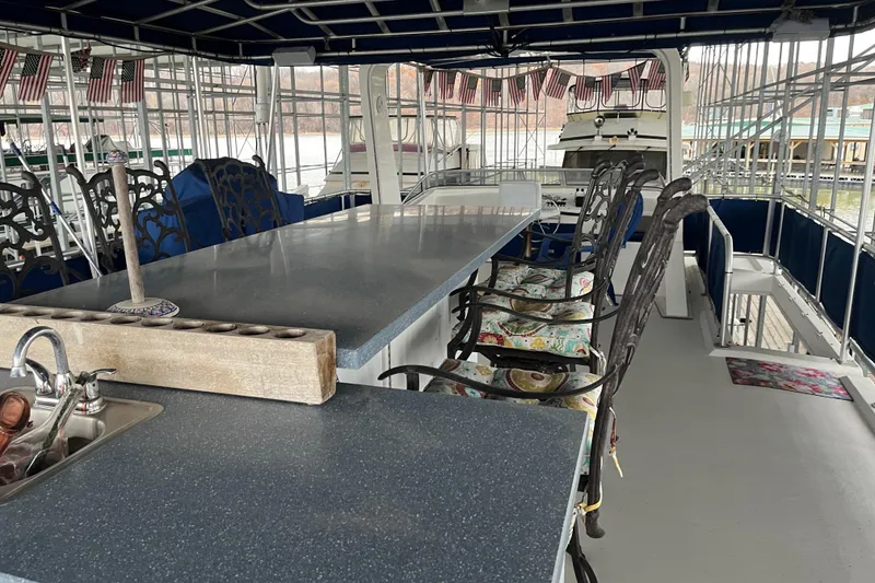 Slide: The Image of Spacious 2010 Funtime 68x16 houseboat interior with dining area and kitchen sink. - 33