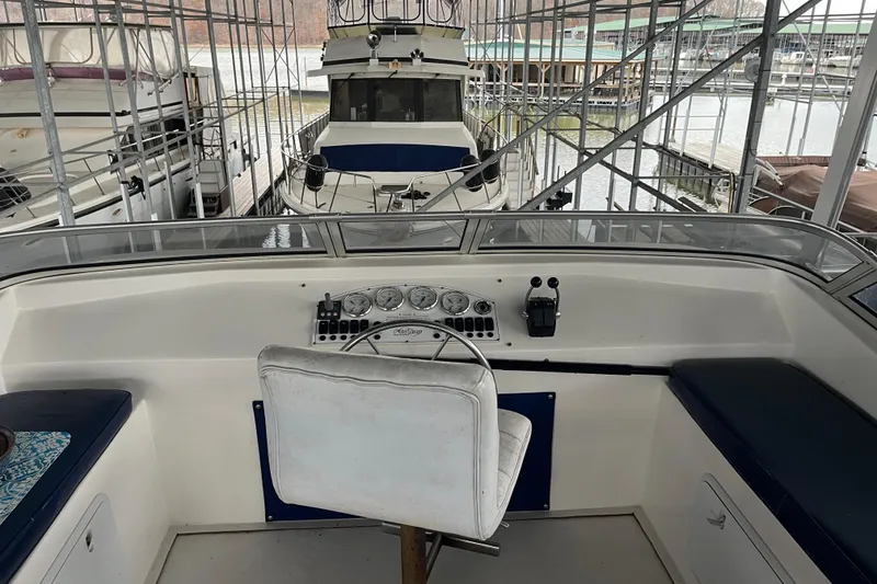 Slide: The Image of Interior view of a 2010 Funtime 68x16 boat cockpit with control panel and seating. - 34