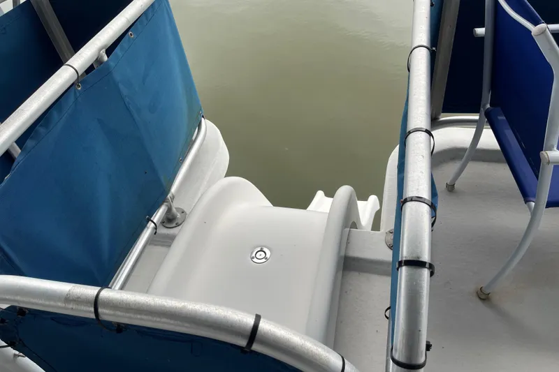Slide: The Image of Funtime 68x16 boat deck with blue seating, 2010 model, overlooking water. - 36