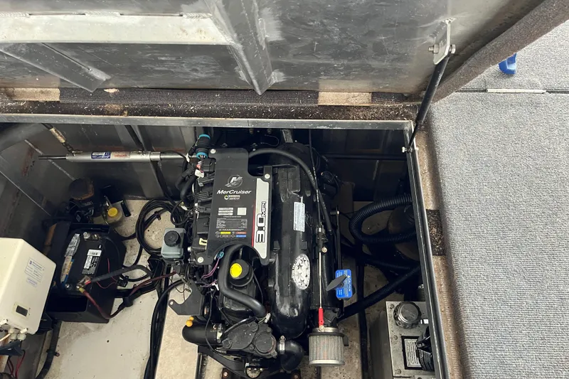 Slide: The Image of Engine compartment of a 2010 Funtime 68x16 boat, featuring a MerCruiser engine. - 37