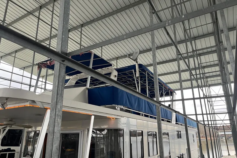 Slide: The Image of Houseboat under metal canopy, Funtime 68x16, 2010 model, with blue covers. - 5