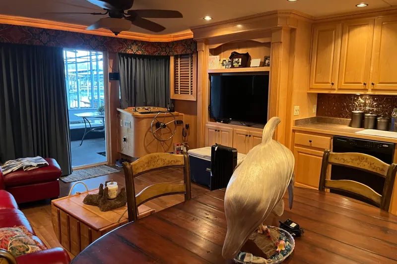 Slide: The Image of Cozy houseboat interior with wooden cabinets, dining table, and large bird sculpture. - 9