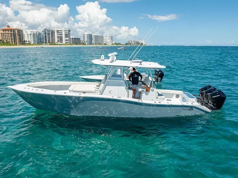 Slide: The Image of 2025 Billfish 39 Center Console boat on clear blue ocean near city skyline. - 0