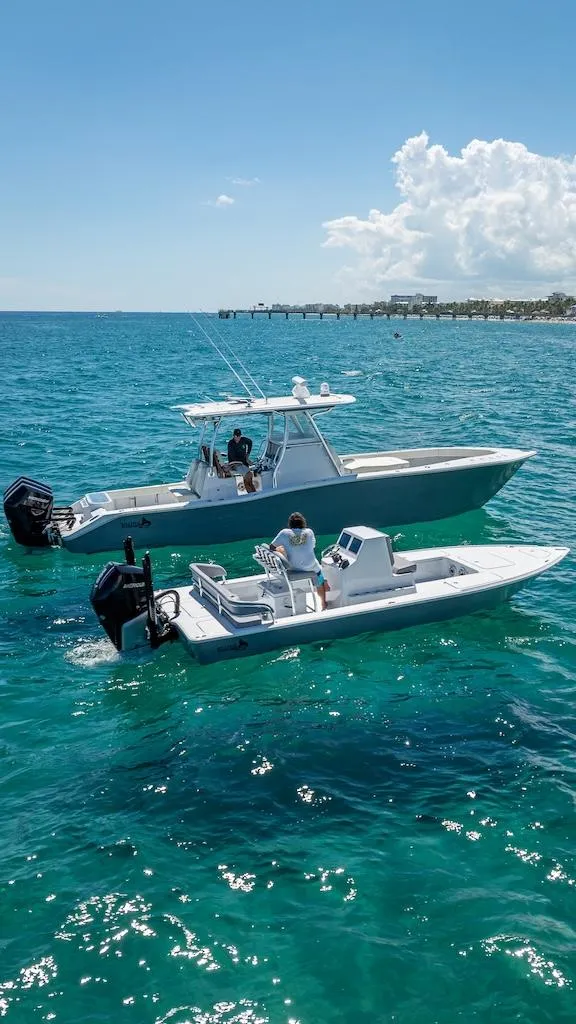 Slide: The Image of 2025 Billfish 39 Center Console boats on clear blue ocean water. - 19