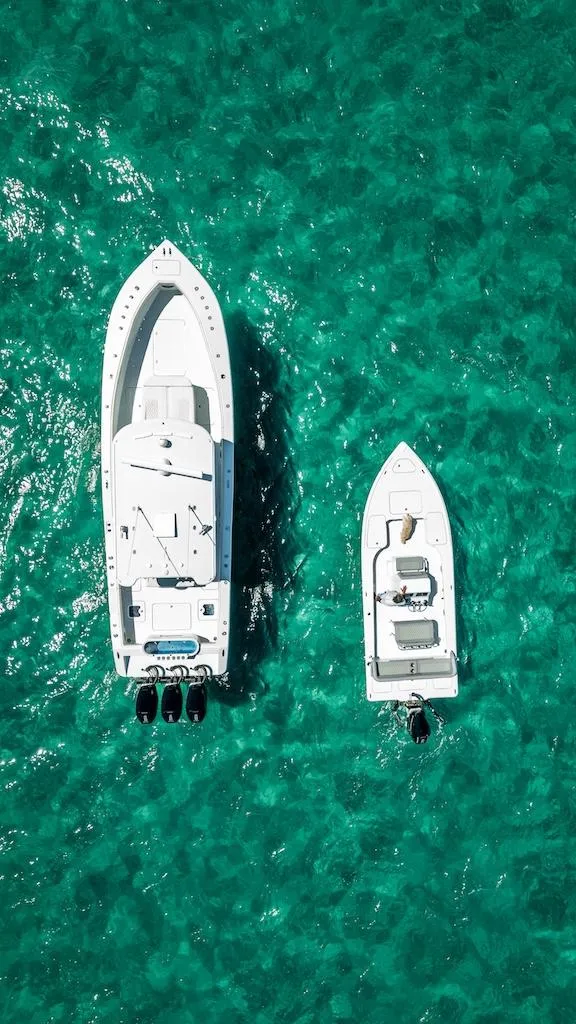 Slide: The Image of Aerial view of 2025 Billfish 39 Center Console boat on turquoise water. - 25