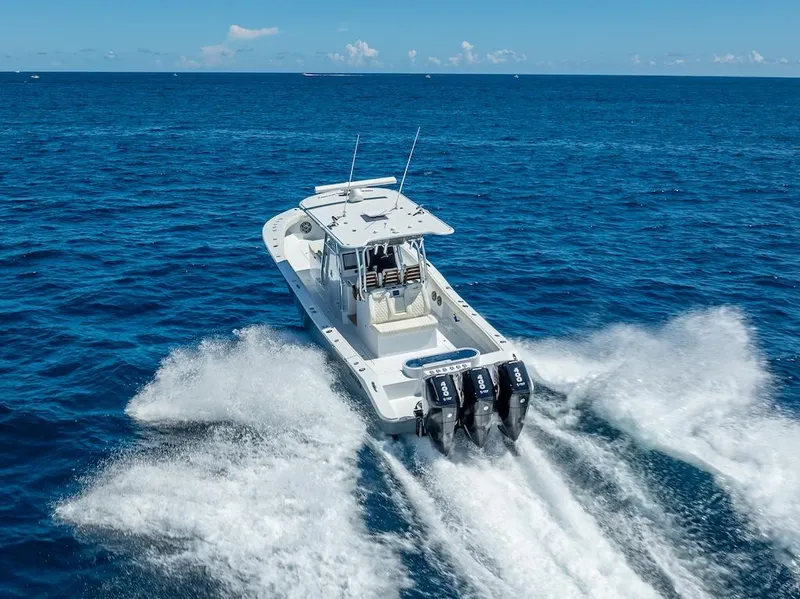 Slide: The Image of 2025 Billfish 39 Center Console boat speeding on open ocean. - 39