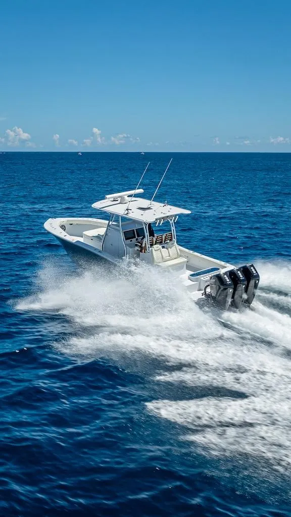Slide: The Image of 2025 Billfish 39 Center Console boat speeding on open ocean. - 40