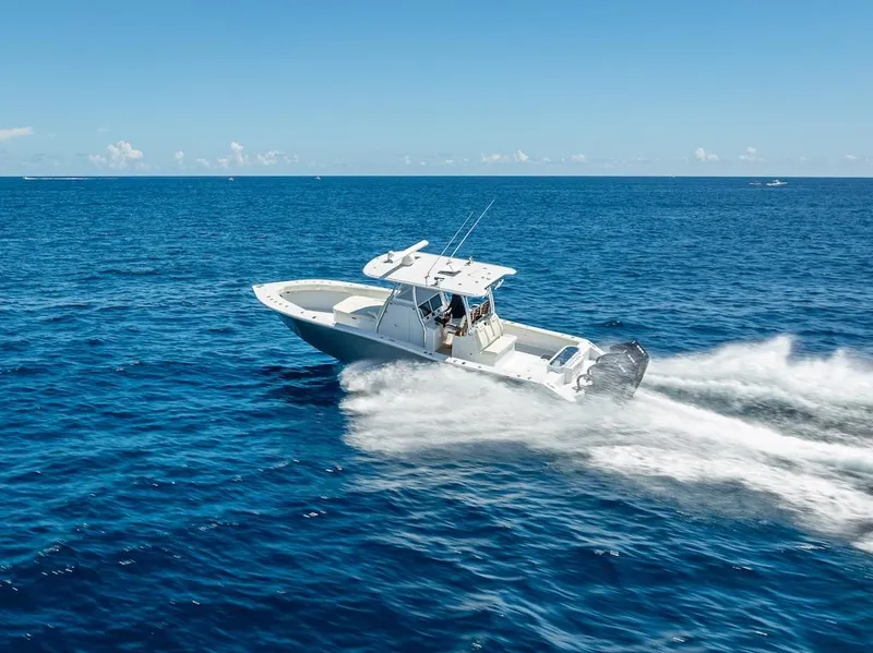 Slide: The Image of 2025 Billfish 39 Center Console boat speeding on open ocean. - 41