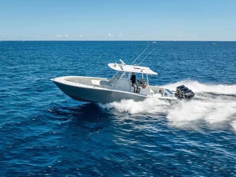 Slide: The Image of 2025 Billfish 39 Center Console boat speeding on open ocean. - 43