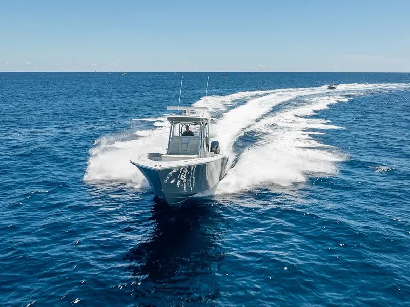 Slide: The Image of 2025 Billfish 39 Center Console boat cruising on open ocean. - 48
