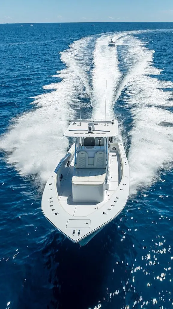 Slide: The Image of 2025 Billfish 39 Center Console boat cruising on open ocean. - 49